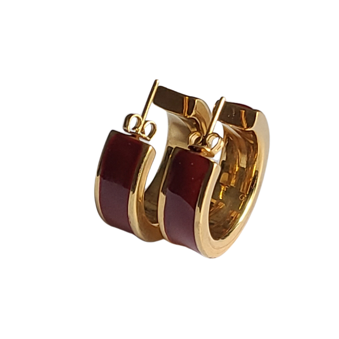 Elegant light gold hoops with a minimalist yet stylish modern design, complemented by meticulous enamel work