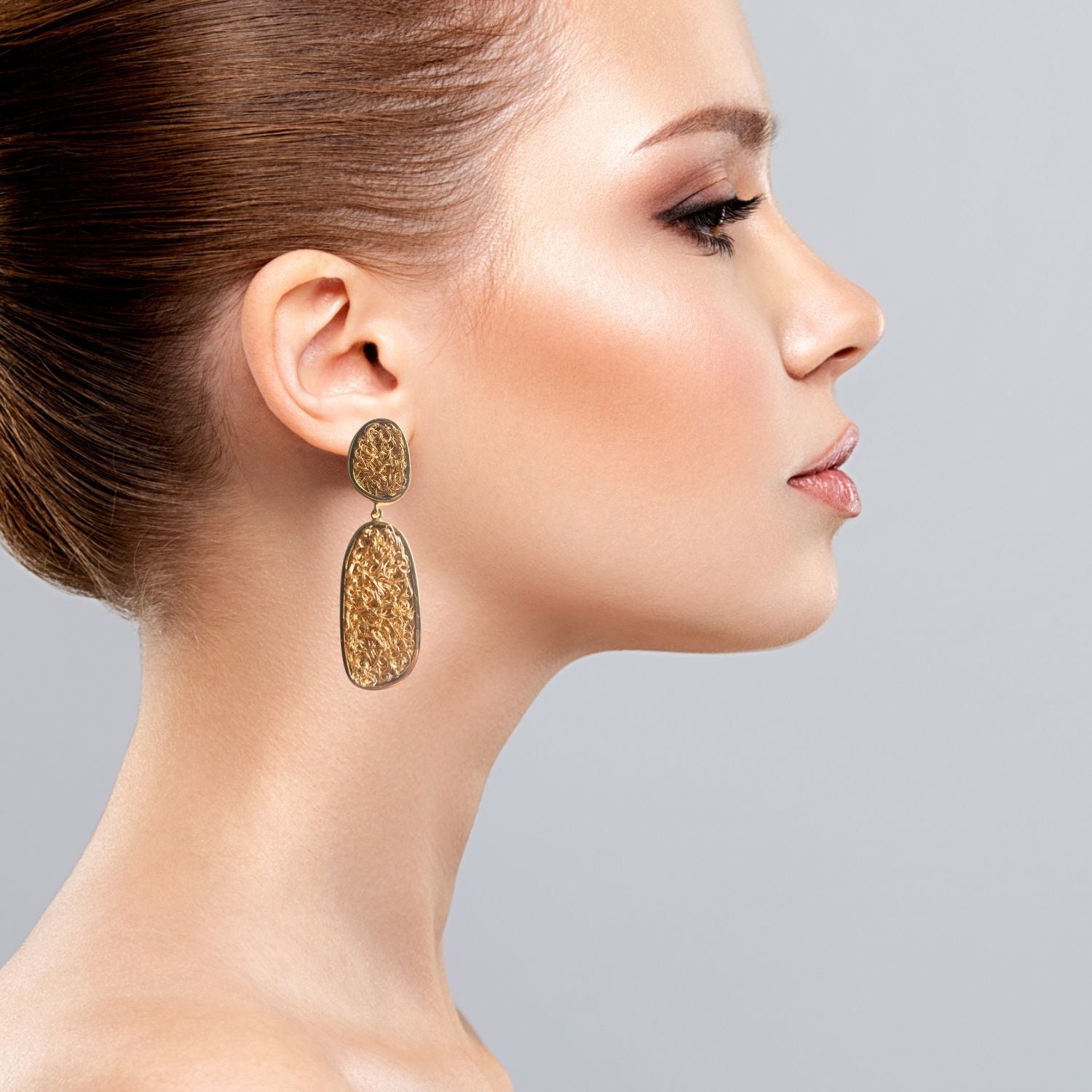 Artisan-crafted dangle earrings featuring delicate gold crochet work 