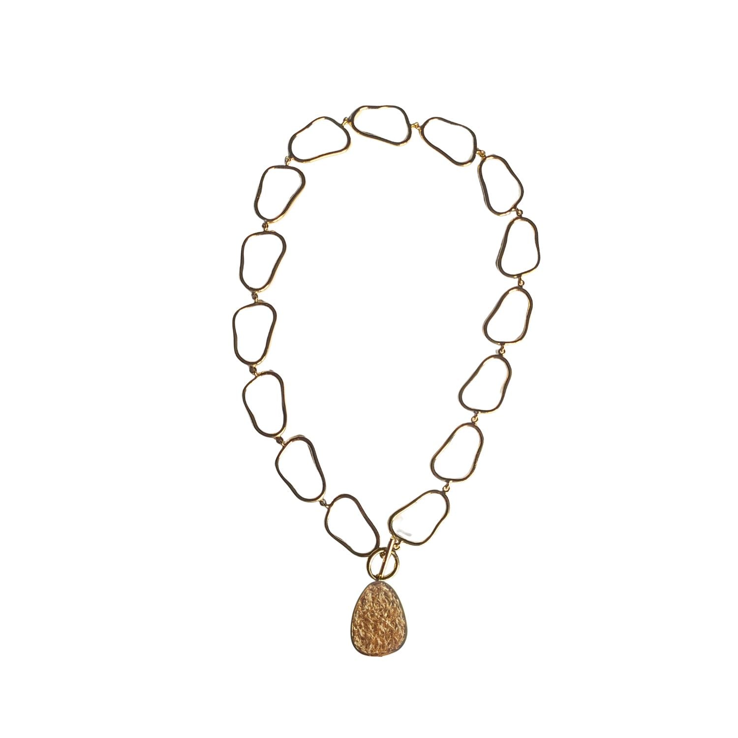 Sleek and contemporary gold/green necklace with a unique pendant, making a statement in modern fashion.