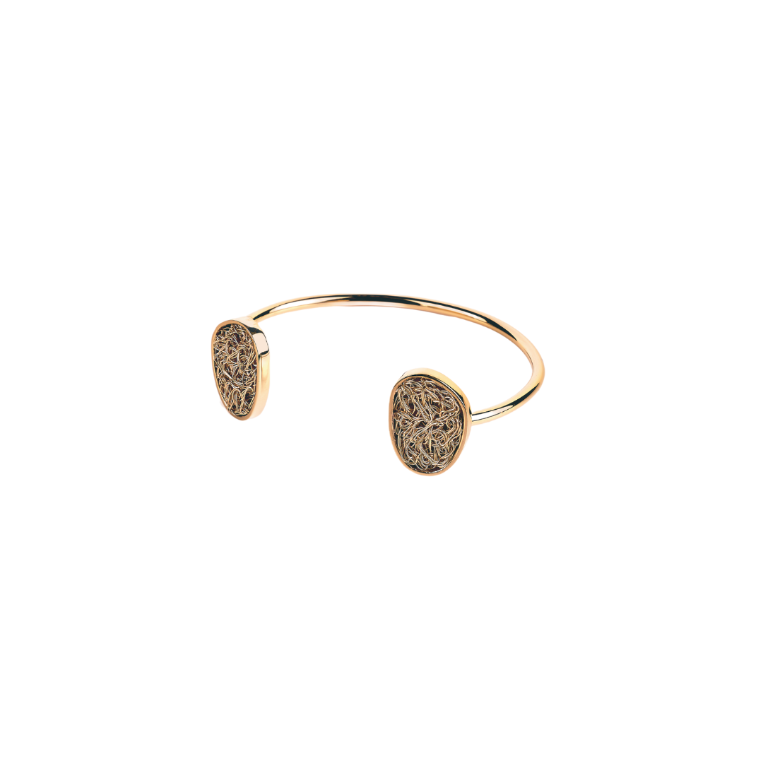 Minimalist and unique gold bracelet, showcasing a sleek and modern silhouette for versatile styling.