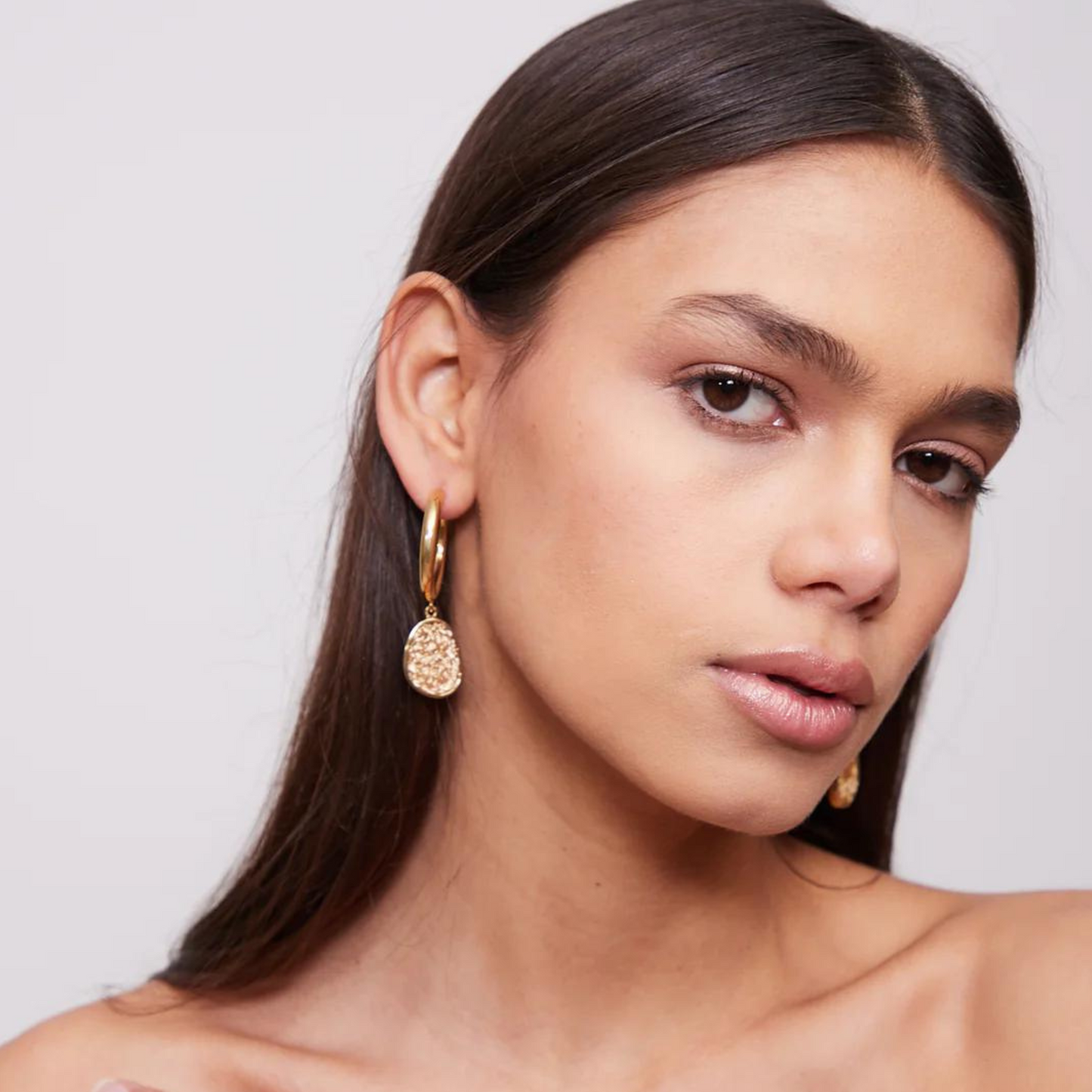 Handmade light gold hoops showcasing a unique fusion of modern aesthetics and delicate crochet craftsmanship.