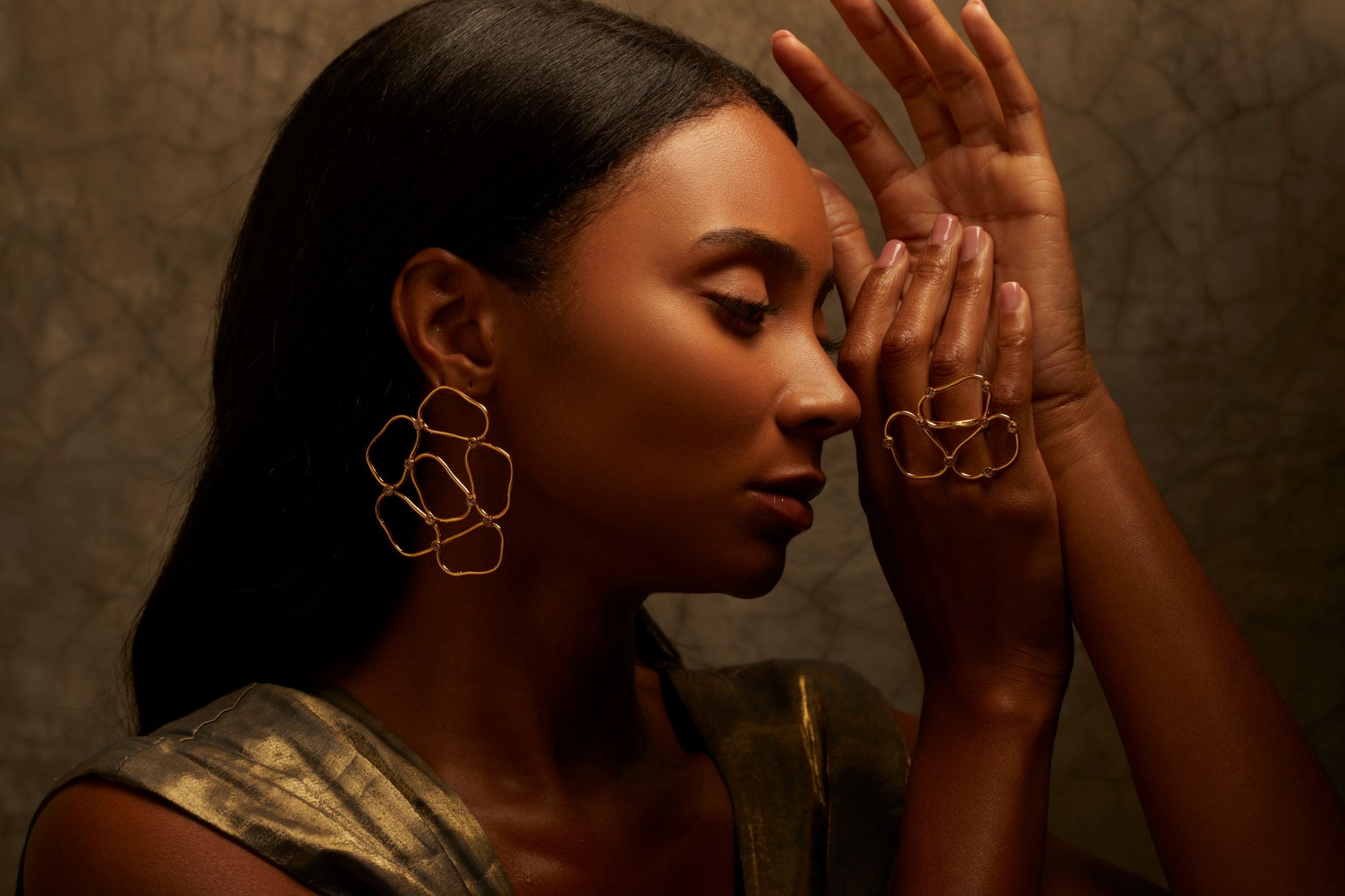 Artistic statement gold earrings with a crochet-inspired design 